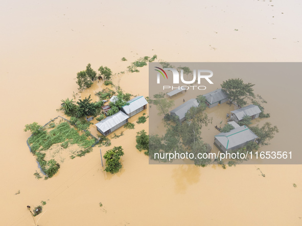 Heavy rains and water from upstream India submerge homes in a village in Jhenaigati upazila of Sherpur district, Bangladesh, on October 5, 2...