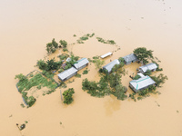 Heavy rains and water from upstream India submerge homes in a village in Jhenaigati upazila of Sherpur district, Bangladesh, on October 5, 2...