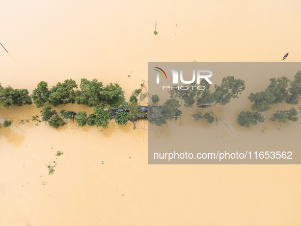 Heavy rains and water from upstream India submerge roads in a village in Jhenaigati upazila of Sherpur district in Sherpur, Bangladesh, on O...