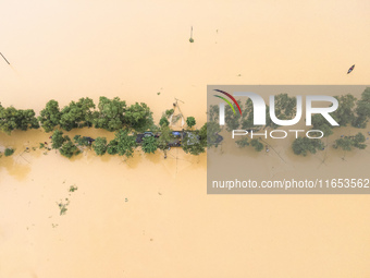 Heavy rains and water from upstream India submerge roads in a village in Jhenaigati upazila of Sherpur district in Sherpur, Bangladesh, on O...