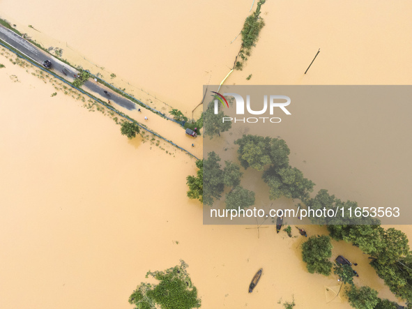 Heavy rains and water from upstream India submerge roads in a village in Jhenaigati upazila of Sherpur district in Sherpur, Bangladesh, on O...