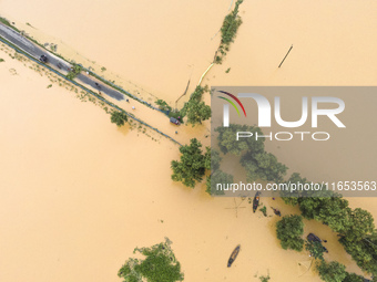 Heavy rains and water from upstream India submerge roads in a village in Jhenaigati upazila of Sherpur district in Sherpur, Bangladesh, on O...