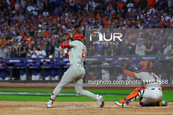 Alec Bohm #28 of the Philadelphia Phillies drives in a run on a fielder's choice during the fourth inning in Game 4 of the baseball NL Divis...