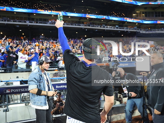 Pete Alonso #20 of the New York Mets celebrates with a teammate after winning the NL Division Series against the Philadelphia Phillies at Ci...