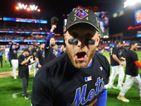 Harrison Bader #44 of the New York Mets celebrates with a teammate after winning the NL Division Series against the Philadelphia Phillies at...