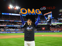 Jose Iglesias #11 of the New York Mets celebrates with a teammate after winning the NL Division Series against the Philadelphia Phillies at...