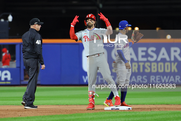 Philadelphia Phillies' Bryce Harper #3 gestures to the bench after doubling during the sixth inning in Game 4 of the baseball NL Division Se...