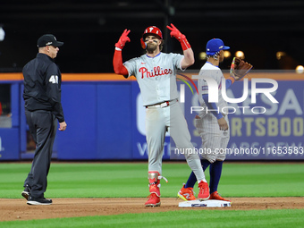 Philadelphia Phillies' Bryce Harper #3 gestures to the bench after doubling during the sixth inning in Game 4 of the baseball NL Division Se...