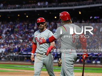 Bryce Harper #3 of the Philadelphia Phillies is congratulated after scoring during the fourth inning in Game 4 of the baseball NL Division S...