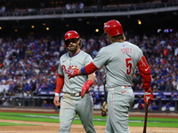 Bryce Harper #3 of the Philadelphia Phillies is congratulated after scoring during the fourth inning in Game 4 of the baseball NL Division S...