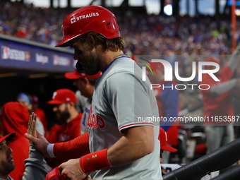 Bryce Harper #3 of the Philadelphia Phillies is congratulated after scoring during the fourth inning in Game 4 of the baseball NL Division S...