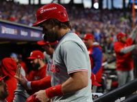 Bryce Harper #3 of the Philadelphia Phillies is congratulated after scoring during the fourth inning in Game 4 of the baseball NL Division S...