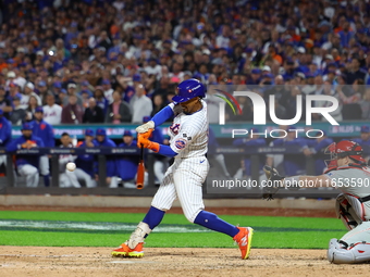 New York Mets player Francisco Lindor #12 hits a grand slam home run during the sixth inning in Game 4 of a baseball NL Division Series agai...