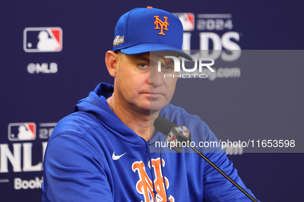 New York Mets manager Carlos Mendoza #64 speaks to the media during a press conference prior to Game 4 of a baseball NL Division Series agai...