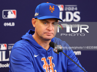 New York Mets manager Carlos Mendoza #64 speaks to the media during a press conference prior to Game 4 of a baseball NL Division Series agai...