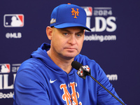 New York Mets manager Carlos Mendoza #64 speaks to the media during a press conference prior to Game 4 of a baseball NL Division Series agai...