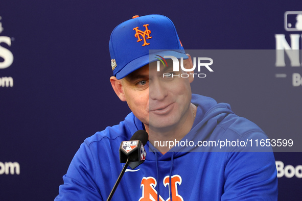 New York Mets manager Carlos Mendoza #64 speaks to the media during a press conference prior to Game 4 of a baseball NL Division Series agai...