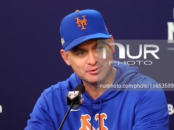 New York Mets manager Carlos Mendoza #64 speaks to the media during a press conference prior to Game 4 of a baseball NL Division Series agai...