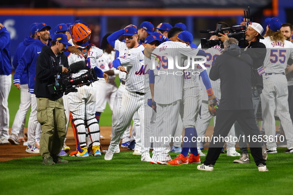 The New York Mets celebrate their 4-1 victory in Game 4 of a baseball NL Division Series against the Philadelphia Phillies at Citi Field in...