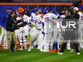 The New York Mets celebrate their 4-1 victory in Game 4 of a baseball NL Division Series against the Philadelphia Phillies at Citi Field in...