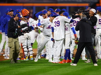 The New York Mets celebrate their 4-1 victory in Game 4 of a baseball NL Division Series against the Philadelphia Phillies at Citi Field in...