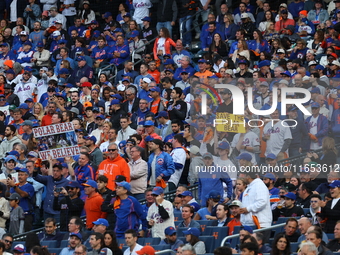 A New York Mets fan holds up a sign during the second inning in Game 4 of the baseball NL Division Series against the Philadelphia Phillies...