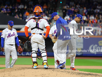 New York Mets manager Carlos Mendoza #64 removes pitcher Jose Quintana #62 from the game during the sixth inning in Game 4 of the baseball N...