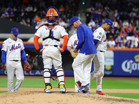 New York Mets manager Carlos Mendoza #64 removes pitcher Jose Quintana #62 from the game during the sixth inning in Game 4 of the baseball N...