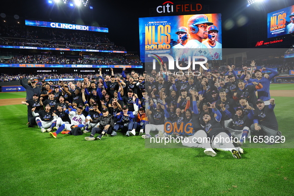 New York Mets players and staff pose for a photo after winning the NLDS against the Philadelphia Phillies at Citi Field in Flushing, N.Y., o...