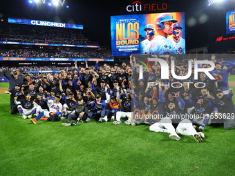 New York Mets players and staff pose for a photo after winning the NLDS against the Philadelphia Phillies at Citi Field in Flushing, N.Y., o...