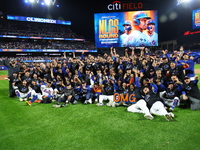 New York Mets players and staff pose for a photo after winning the NLDS against the Philadelphia Phillies at Citi Field in Flushing, N.Y., o...