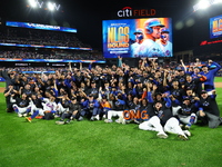 New York Mets players and staff pose for a photo after winning the NLDS against the Philadelphia Phillies at Citi Field in Flushing, N.Y., o...