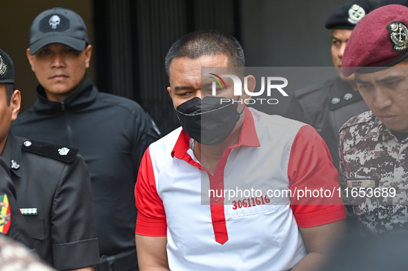 Mongolian model Altantuya Shaariibuu's murderer, Azilah Hadri, is escorted by the prison guards outside the Federal Court in Putrajaya, Mala...