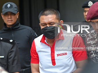 Mongolian model Altantuya Shaariibuu's murderer, Azilah Hadri, is escorted by the prison guards outside the Federal Court in Putrajaya, Mala...