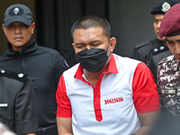 Mongolian model Altantuya Shaariibuu's murderer, Azilah Hadri, is escorted by the prison guards outside the Federal Court in Putrajaya, Mala...