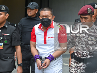 Mongolian model Altantuya Shaariibuu's murderer, Azilah Hadri, is escorted by the prison guards outside the Federal Court in Putrajaya, Mala...