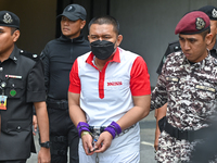 Mongolian model Altantuya Shaariibuu's murderer, Azilah Hadri, is escorted by the prison guards outside the Federal Court in Putrajaya, Mala...