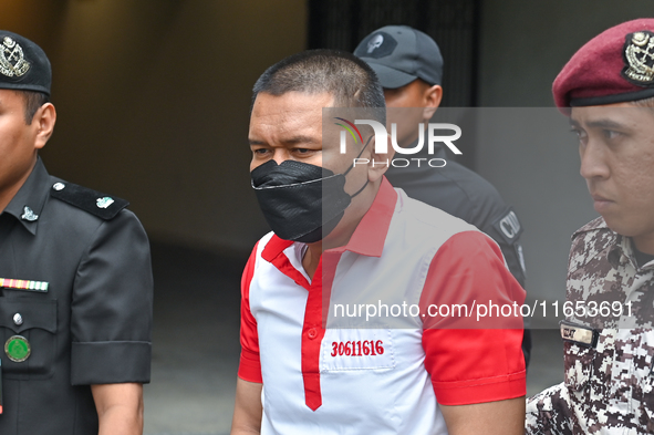 Mongolian model Altantuya Shaariibuu's murderer, Azilah Hadri, is escorted by the prison guards outside the Federal Court in Putrajaya, Mala...