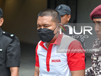 Mongolian model Altantuya Shaariibuu's murderer, Azilah Hadri, is escorted by the prison guards outside the Federal Court in Putrajaya, Mala...