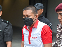 Mongolian model Altantuya Shaariibuu's murderer, Azilah Hadri, is escorted by the prison guards outside the Federal Court in Putrajaya, Mala...