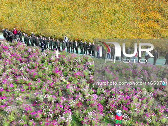 Retired soldiers and teachers visit a scenic spot to celebrate the upcoming Double Ninth Festival in Lianyungang, Jiangsu province, China, o...