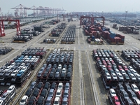 A batch of cars is about to be exported to overseas markets through frame transport at the International Container Terminal in Taicang Port...