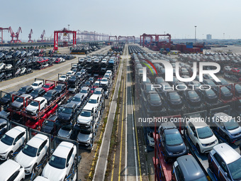 A batch of cars is about to be exported to overseas markets through frame transport at the International Container Terminal in Taicang Port...