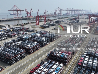 A batch of cars is about to be exported to overseas markets through frame transport at the International Container Terminal in Taicang Port...