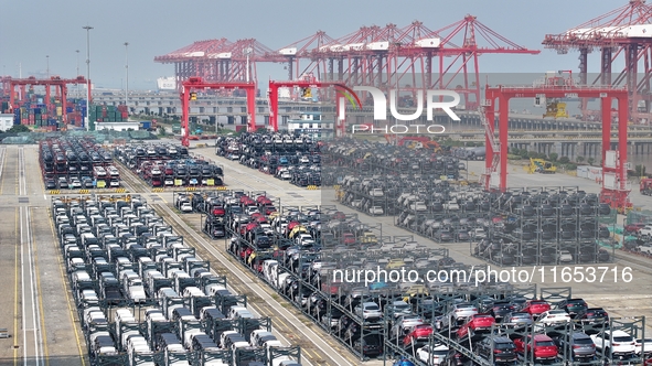 A batch of cars is about to be exported to overseas markets through frame transport at the International Container Terminal in Taicang Port...