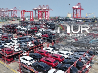 A batch of cars is about to be exported to overseas markets through frame transport at the International Container Terminal in Taicang Port...