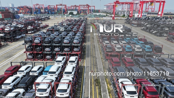 A batch of cars is about to be exported to overseas markets through frame transport at the International Container Terminal in Taicang Port...