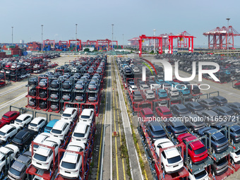 A batch of cars is about to be exported to overseas markets through frame transport at the International Container Terminal in Taicang Port...