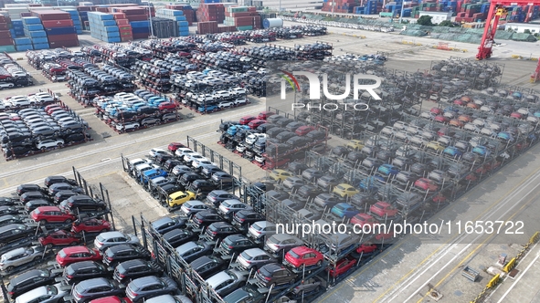 A batch of cars is about to be exported to overseas markets through frame transport at the International Container Terminal in Taicang Port...