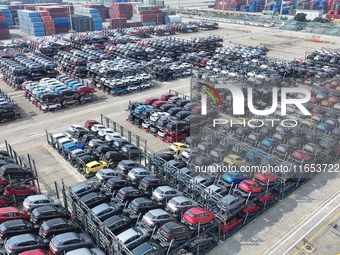 A batch of cars is about to be exported to overseas markets through frame transport at the International Container Terminal in Taicang Port...